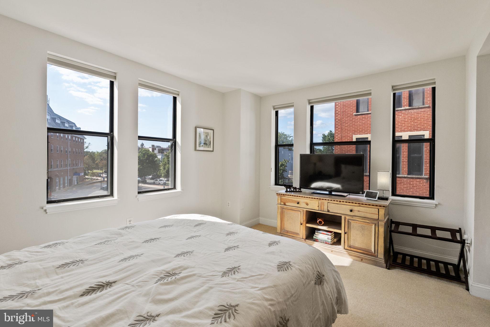 649 C Street Southeast, Unit 304 Washington, DC 20003 - Photo 16 of 37 a bedroom with a bed and a flat screen tv