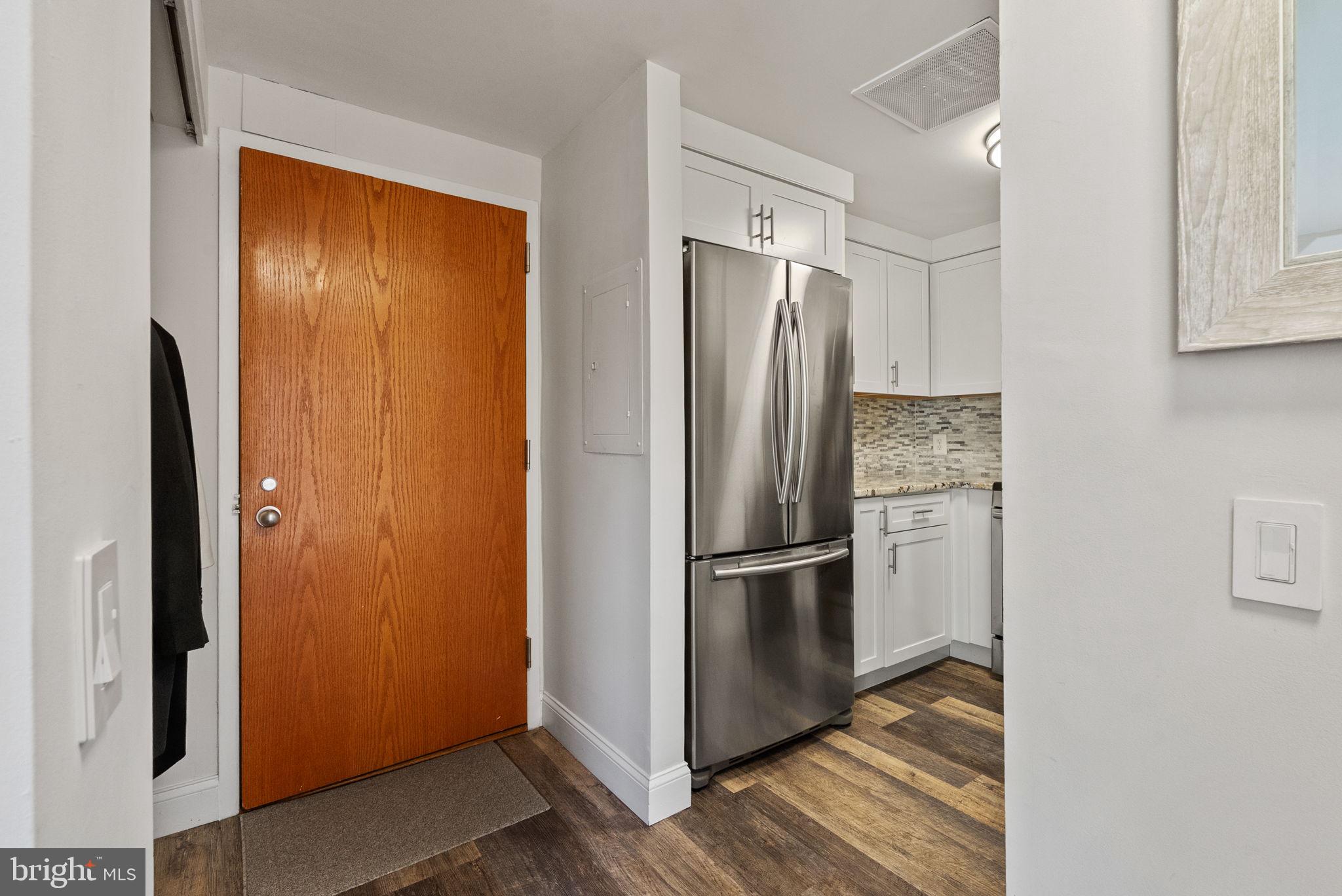 649 C Street Southeast, Unit 304 Washington, DC 20003 - Photo 5 of 37 a kitchen with a refrigerator and wooden floor