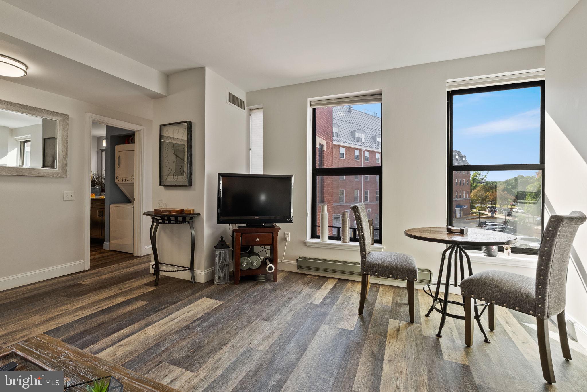 649 C Street Southeast, Unit 304 Washington, DC 20003 - Photo 7 of 37 a living room with furniture and a flat screen tv
