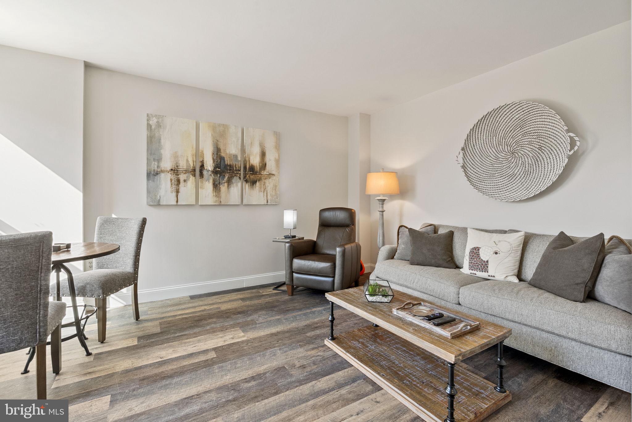 649 C Street Southeast, Unit 304 Washington, DC 20003 - Photo 9 of 37 a living room with furniture and a table