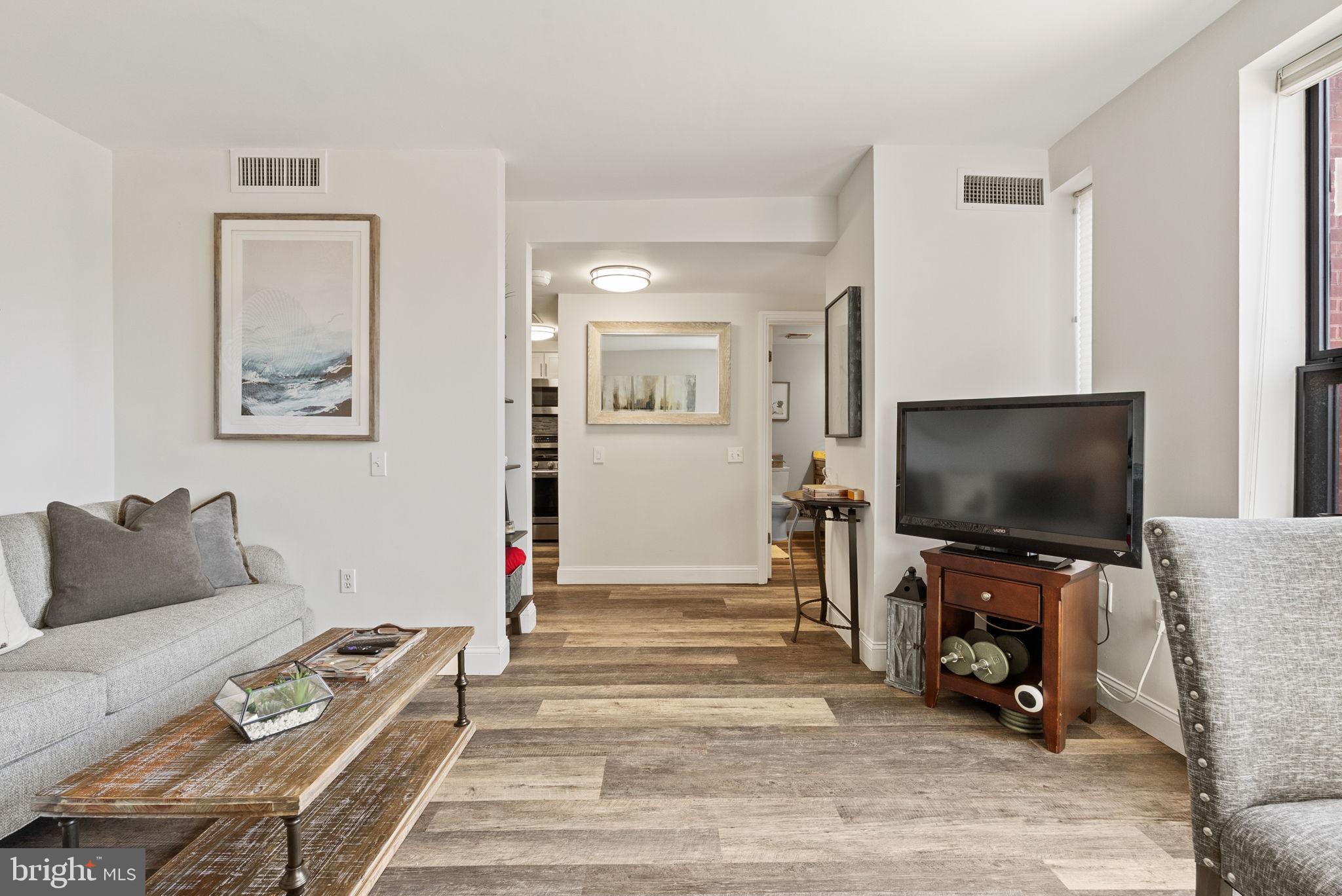 649 C Street Southeast, Unit 304 Washington, DC 20003 - Photo 10 of 37 a living room with furniture and a flat screen tv