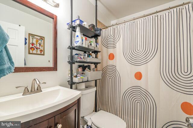 1633 D Street Southeast Washington, DC 20003 - Photo 27 of 38 a bathroom with a sink a toilet and a mirror