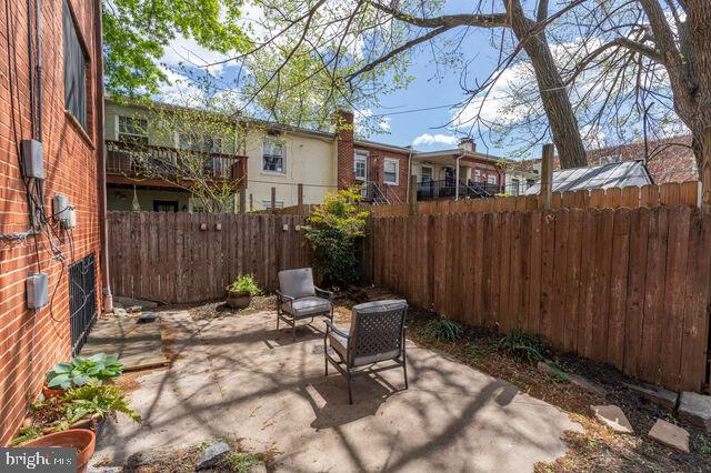 1633 D Street Southeast Washington, DC 20003 - Photo 35 of 38 a view of backyard with table and chairs and wooden fence