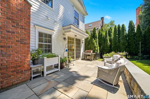 a view of a patio with a table and chairs and potted plants