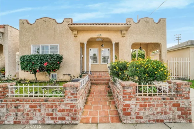 a view of a house with potted plants