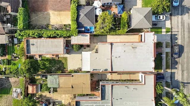 a view of a patio with table and chairs potted plants and floor to ceiling window