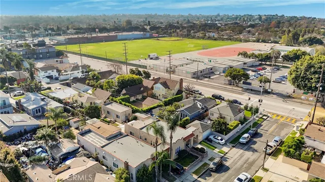 a view of an empty room with a window and a kitchen