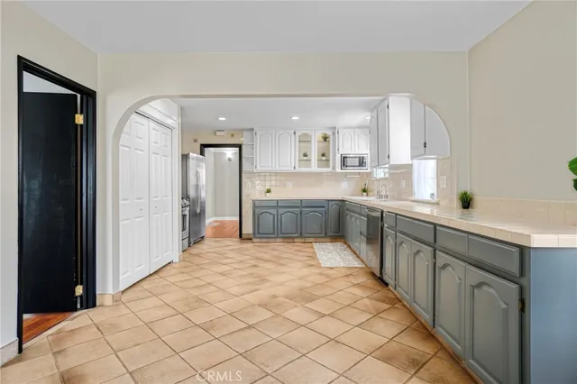 a kitchen with a sink cabinets and window
