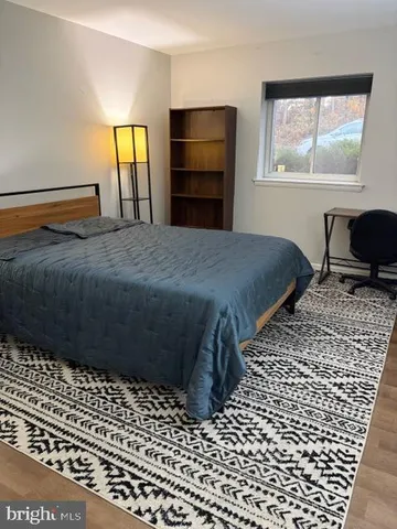 a bedroom with a bed and window