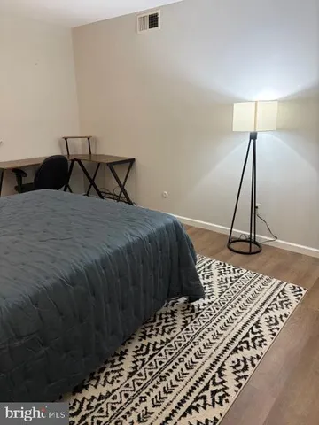 a bedroom with a bed and a lamp on the table
