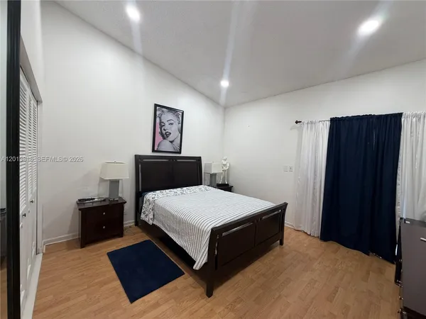 a bedroom with a bed and dresser