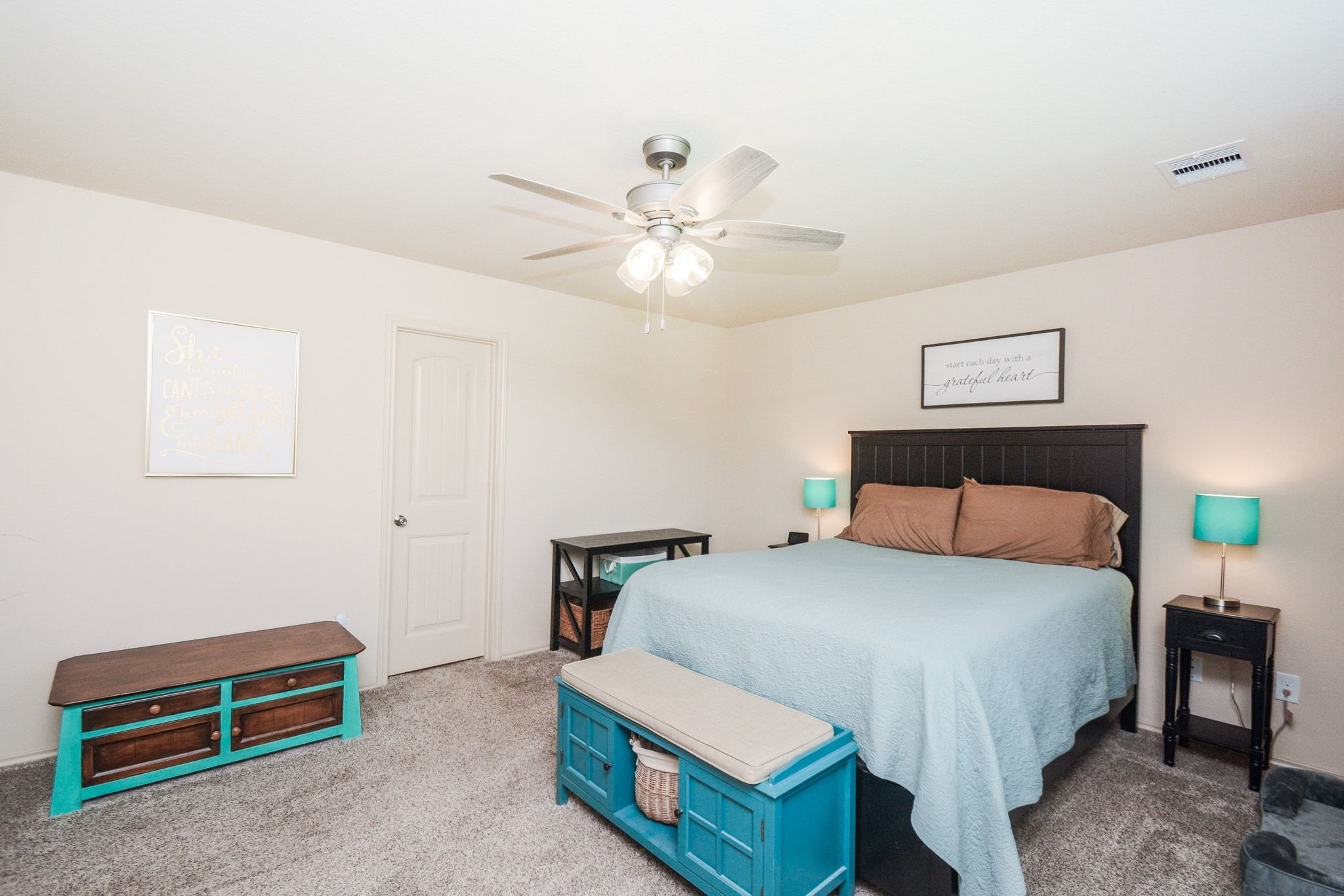 23318 Dukes Run Drive Spring, TX 77373 - Photo 24 of 41 This large primary bedroom features a ceiling fan, neutral walls, and carpeted flooring. There's room for a comfortable bed with bedside tables and lamps, a storage bench, and space to spare.