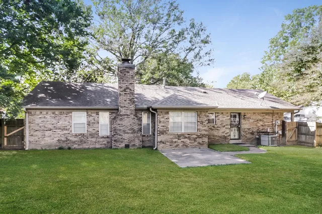 a view of a house with a yard and a garden