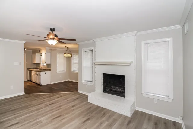 a view of a kitchen and an empty room