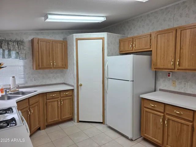 a white refrigerator freezer sitting inside of a kitchen