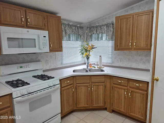 a kitchen with cabinets appliances and a sink