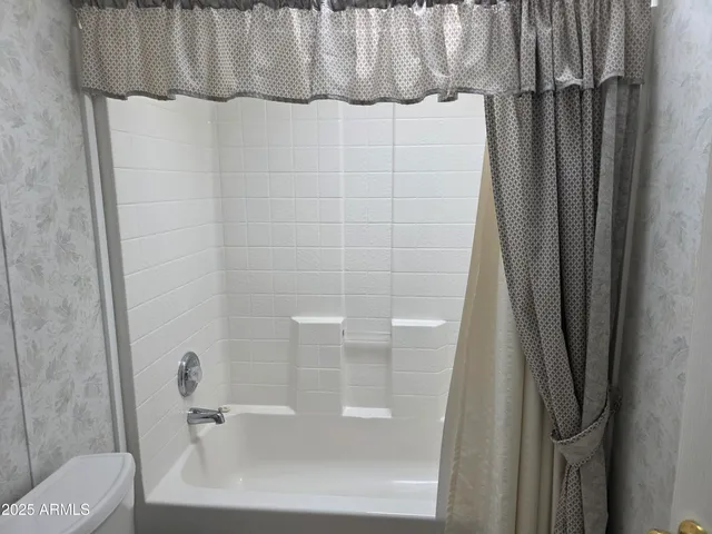 a bathroom with a shower and a sink