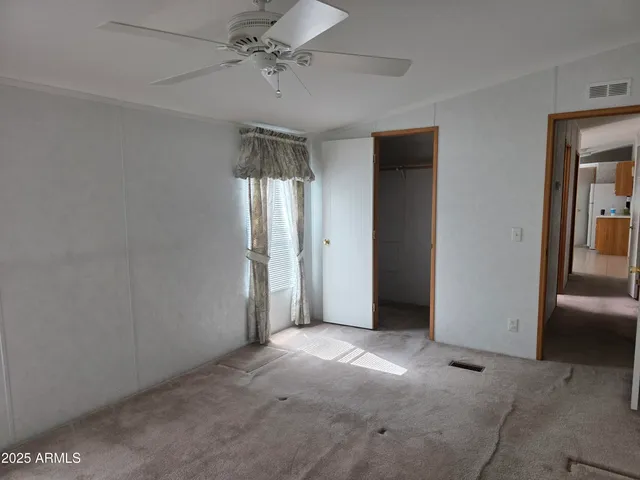 a view of empty room with ceiling fan
