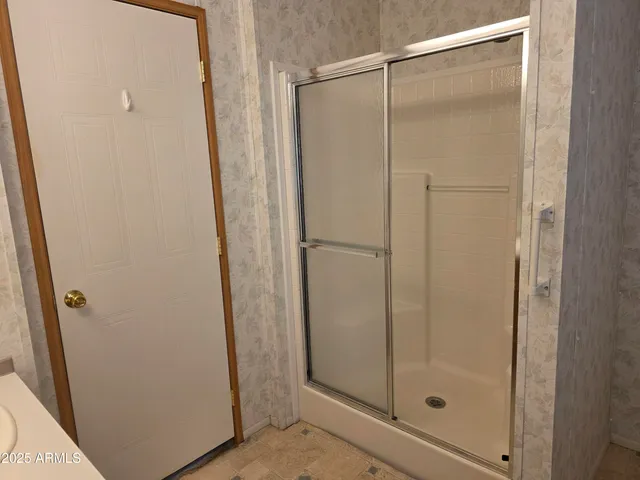 a bathroom with a glass shower door