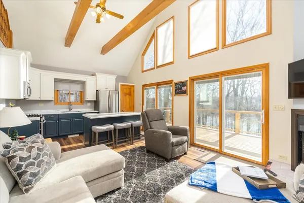 a living room with furniture and a floor to ceiling window
