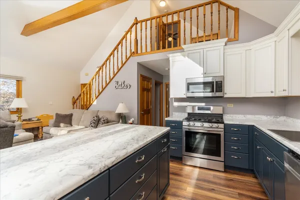 a kitchen with stainless steel appliances granite countertop a stove and cabinets