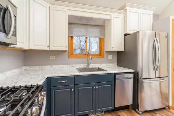 a kitchen with stainless steel appliances granite countertop a refrigerator and a sink
