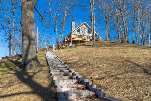 a view of wooden house with a yard