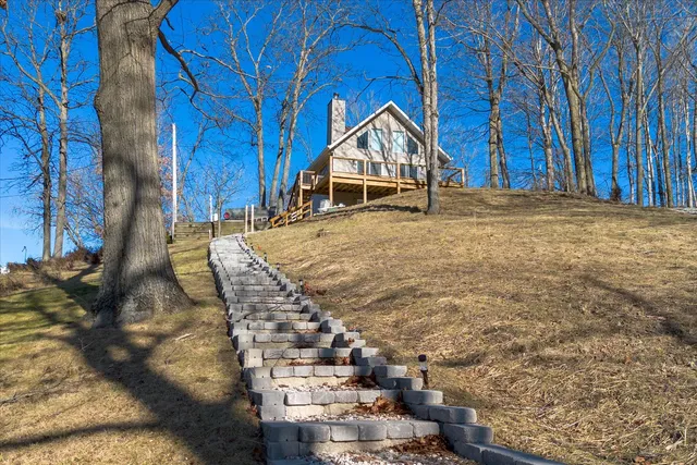 a view of wooden house with a yard