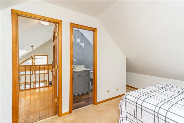 a bedroom with a bed and a mirror