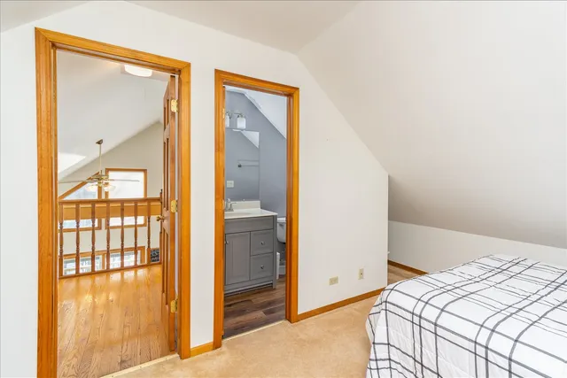 a bedroom with a bed and a mirror