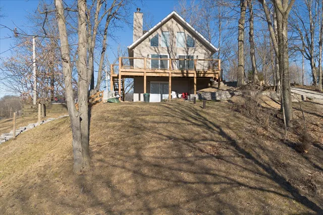 a view of house with outdoor space and car parked