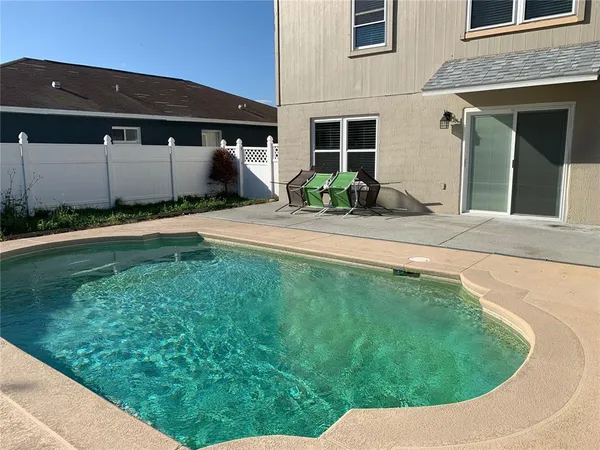 a view of a house with a backyard