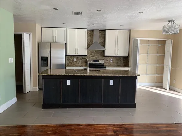 a kitchen with stainless steel appliances granite countertop a sink counter space and cabinets