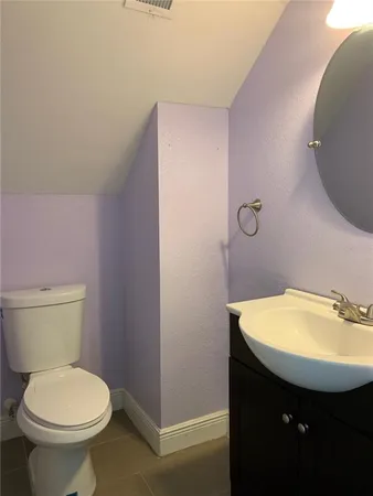 a bathroom with a sink a toilet and mirror