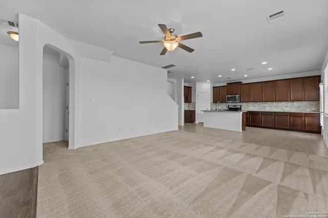 a view of a kitchen with a sink and a window