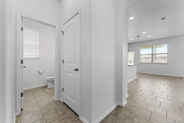 a view of a room with white walls and a window