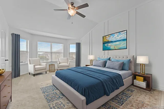 a spacious bedroom with a bed a couch and a window