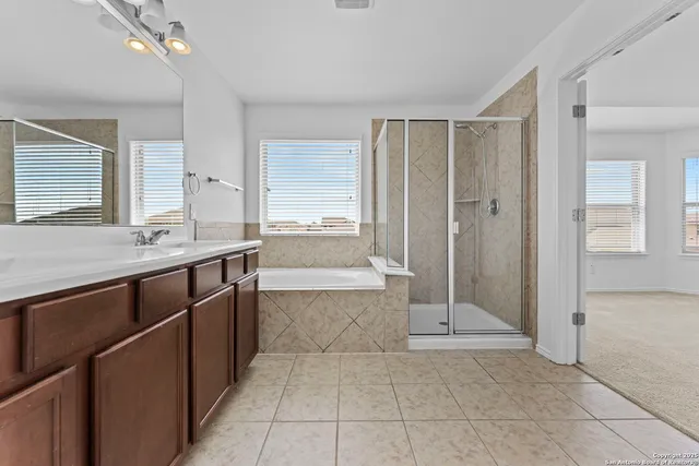 a spacious bathroom with a mirror sink and shower