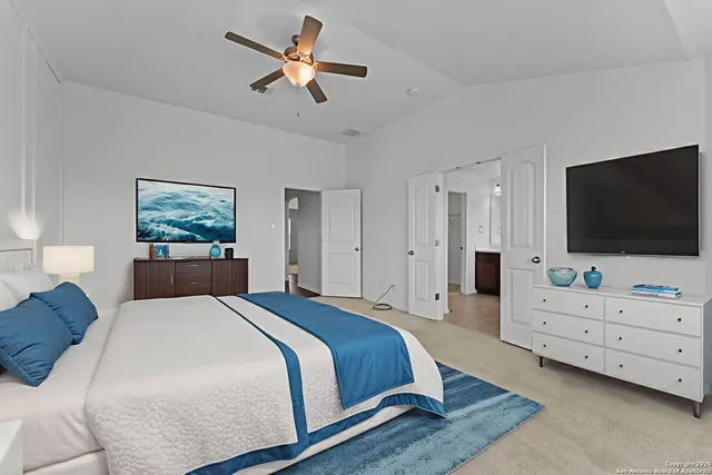 a bedroom with a bed and a flat screen tv on dresser