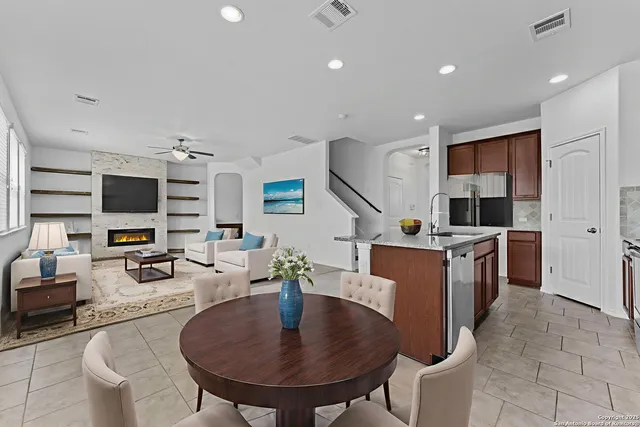 a kitchen with stainless steel appliances kitchen island granite countertop a sink and a refrigerator
