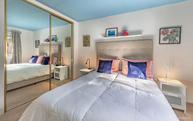 a bedroom with a bed and a large mirror