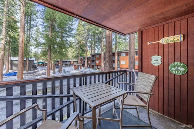 a view of a chairs and table in the balcony