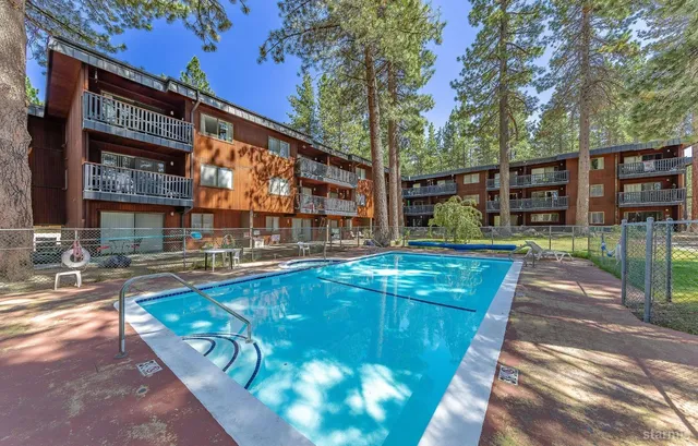 a swimming pool with outdoor seating and yard