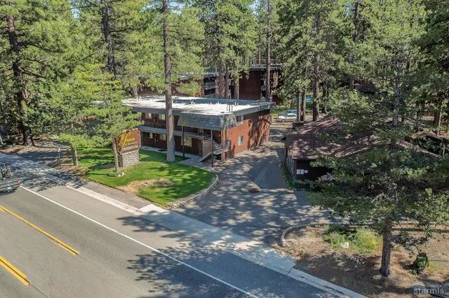 a view of a patio with table and chairs and potted plants