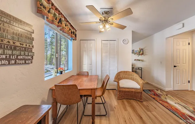 a view of a dining room with furniture and chandelier