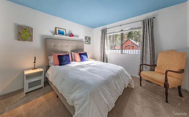 a bedroom with a bed and a chair