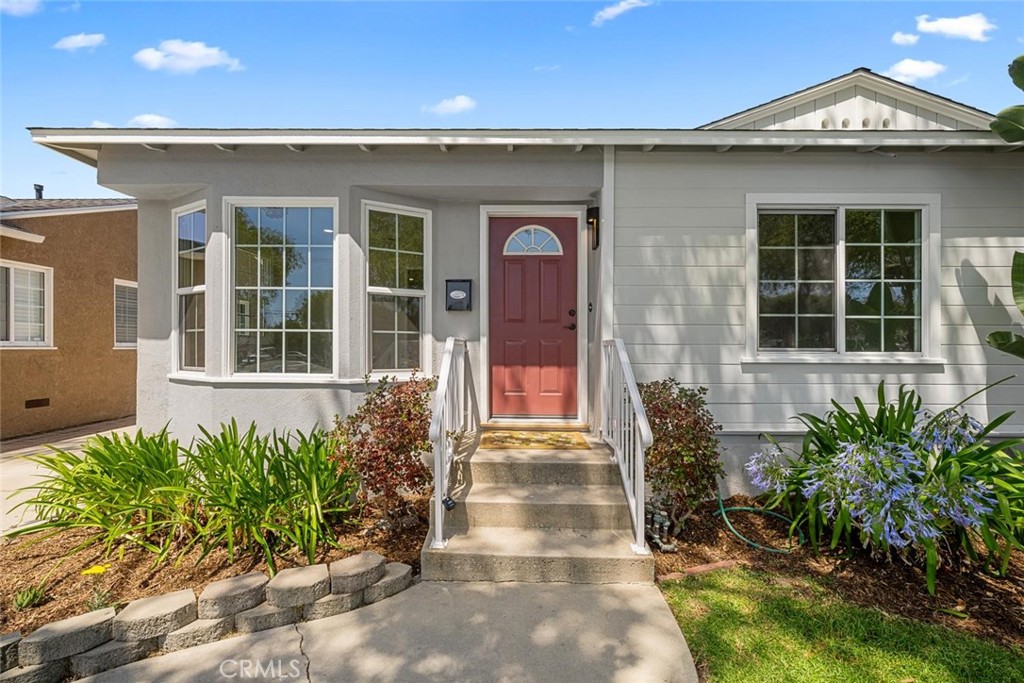 3819 North Studebaker Road Long Beach, CA 90808 - Photo 2 of 62 A cheerful pop of color draws you in, highlighting the home's freshly painted exterior and charming curb appeal.