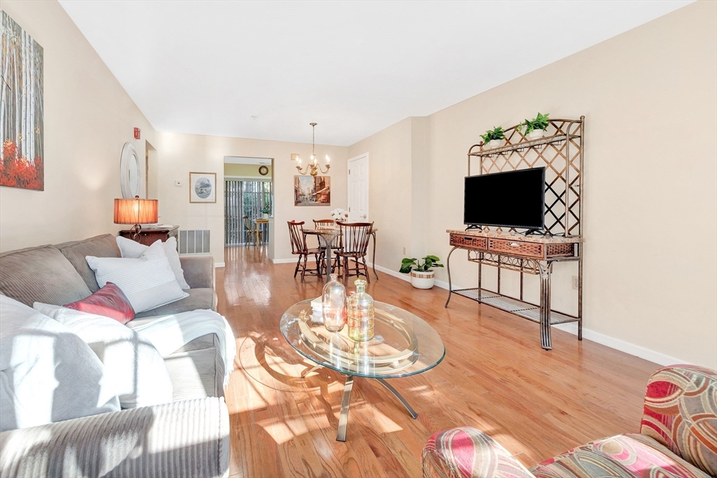 396 Boston Road, Unit 103 Billerica, MA 01821 - Photo 3 of 32 a living room with furniture and a flat screen tv