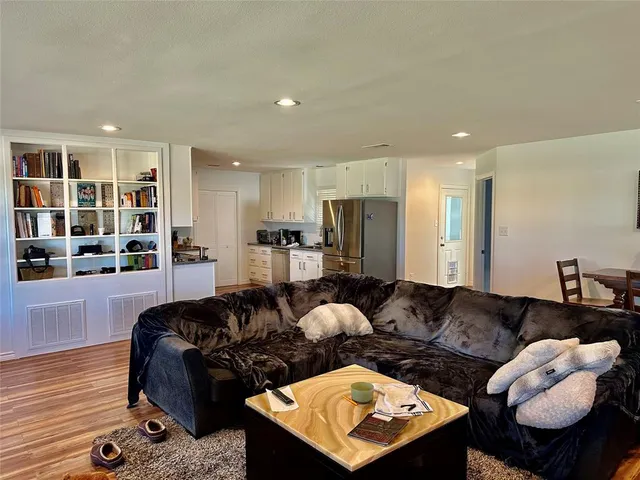 a bedroom with a bed and a flat tv screen on a dresser