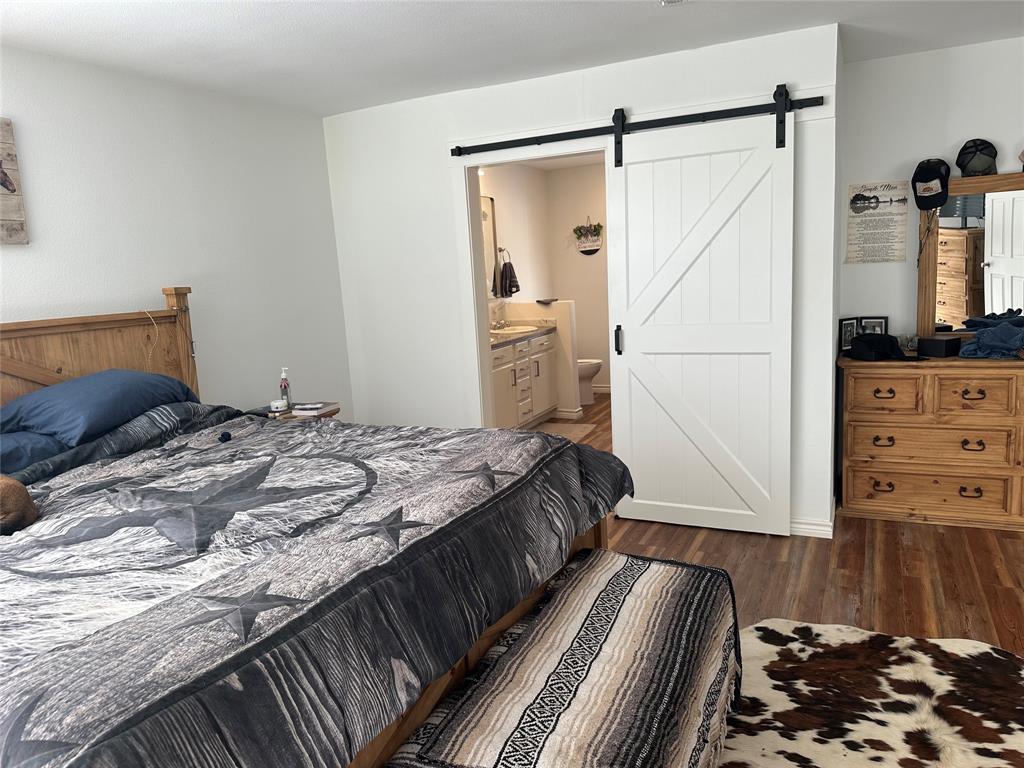 2387 Forehand Road Trinidad, TX 75163 - Photo 15 of 25 a bedroom with a bed and a flat tv screen on a dresser